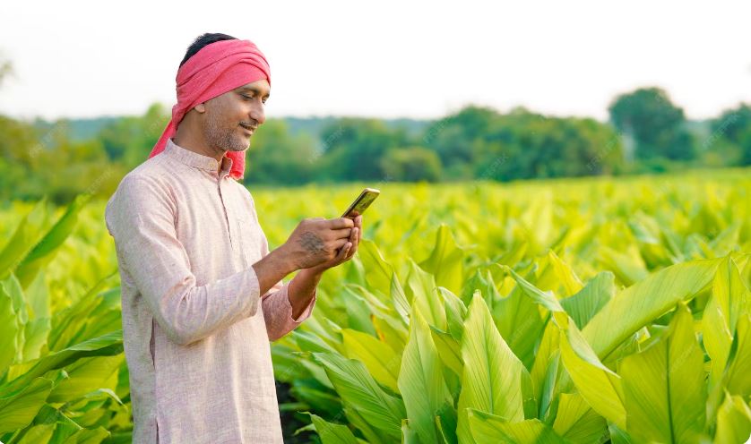 Indian farmer using mobile phone in field